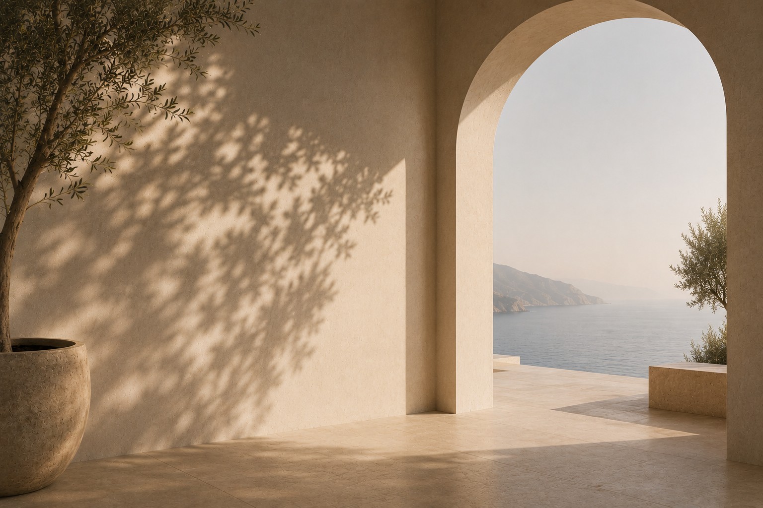 An olive tree casts a dappled shadow across a warm plaster wall beside an archway opening onto a tranquil sea and coastline